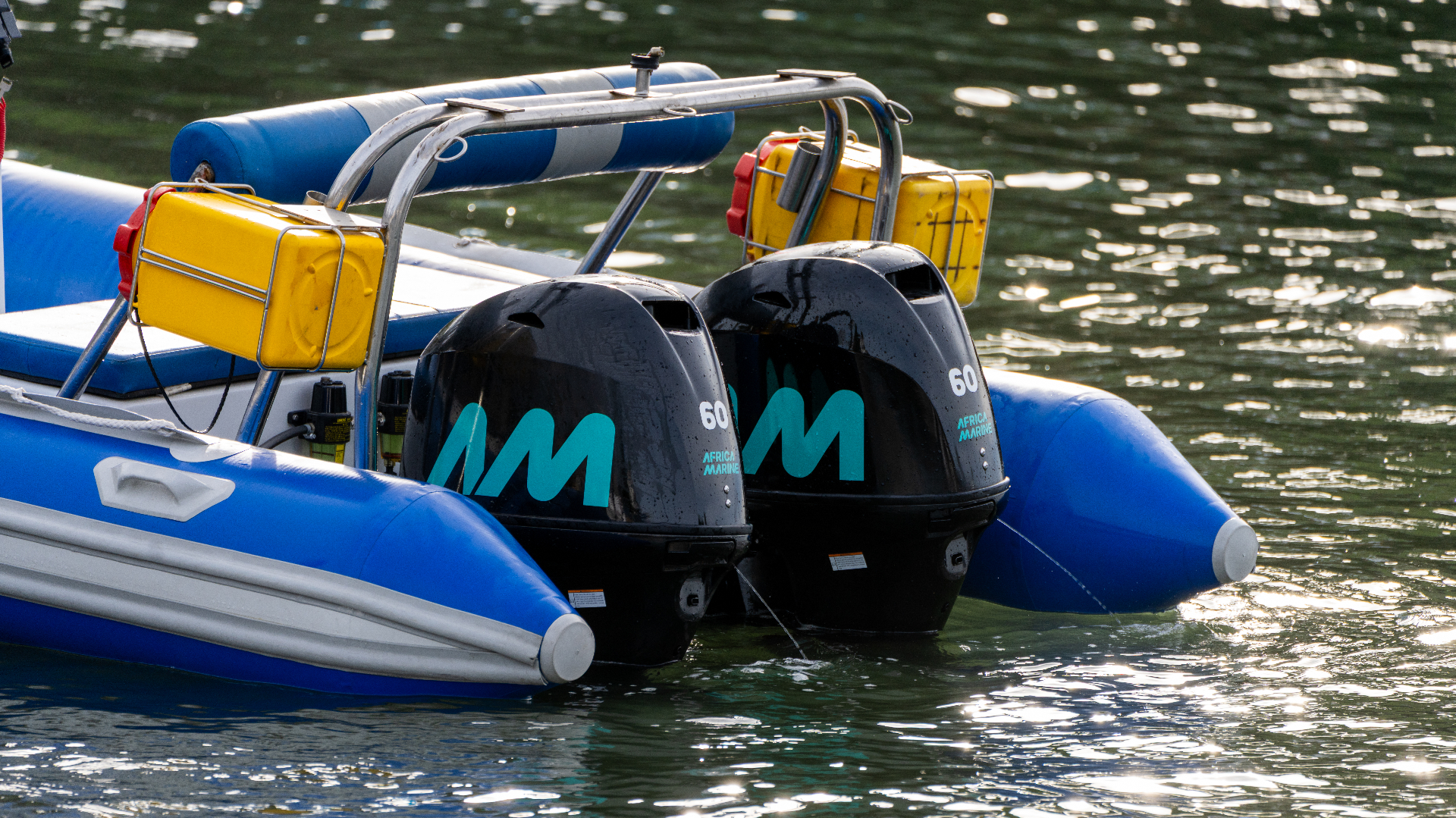 Twin Africa Marine AM60 outboard motors on a blue inflatable boat